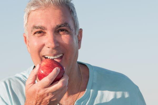 white hills man eating an apple | dentures white hills vic